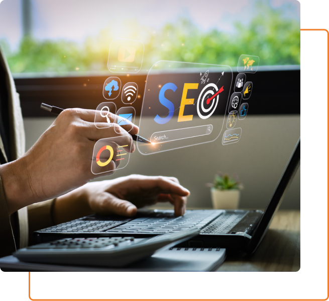 A person sitting at a desk, focused on their laptop screen, working on an SEO service project.